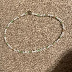 white necklace with green and gold